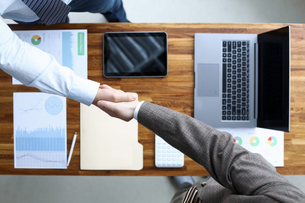 Top view of businessmen handshaking. Partners discussing plans